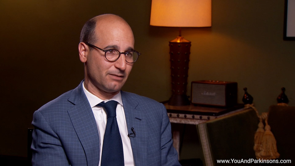 What are motor fluctuations and dyskinesias in Parkinson's disease? How are they treated?
